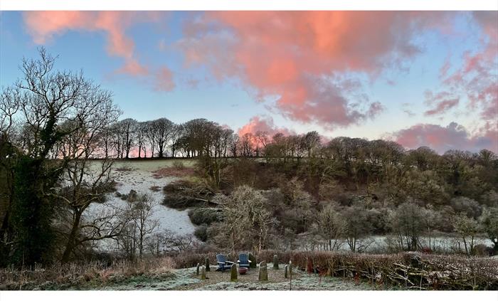 An early morning view across our Carmarthenshire valley with frost on the ground and pink clouds